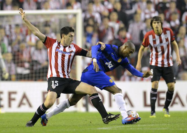 Athletic Bilbao's Iraola challenges Manchester United's Young during their Europa League second leg soccer match at San Mames stadium in Bilbao